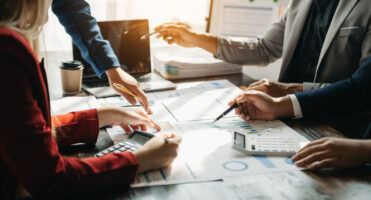 Group of executives analyzing firm finances.